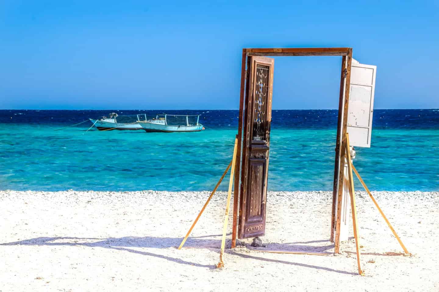 Tropical Red Sea beach with palm trees and clear blue sky