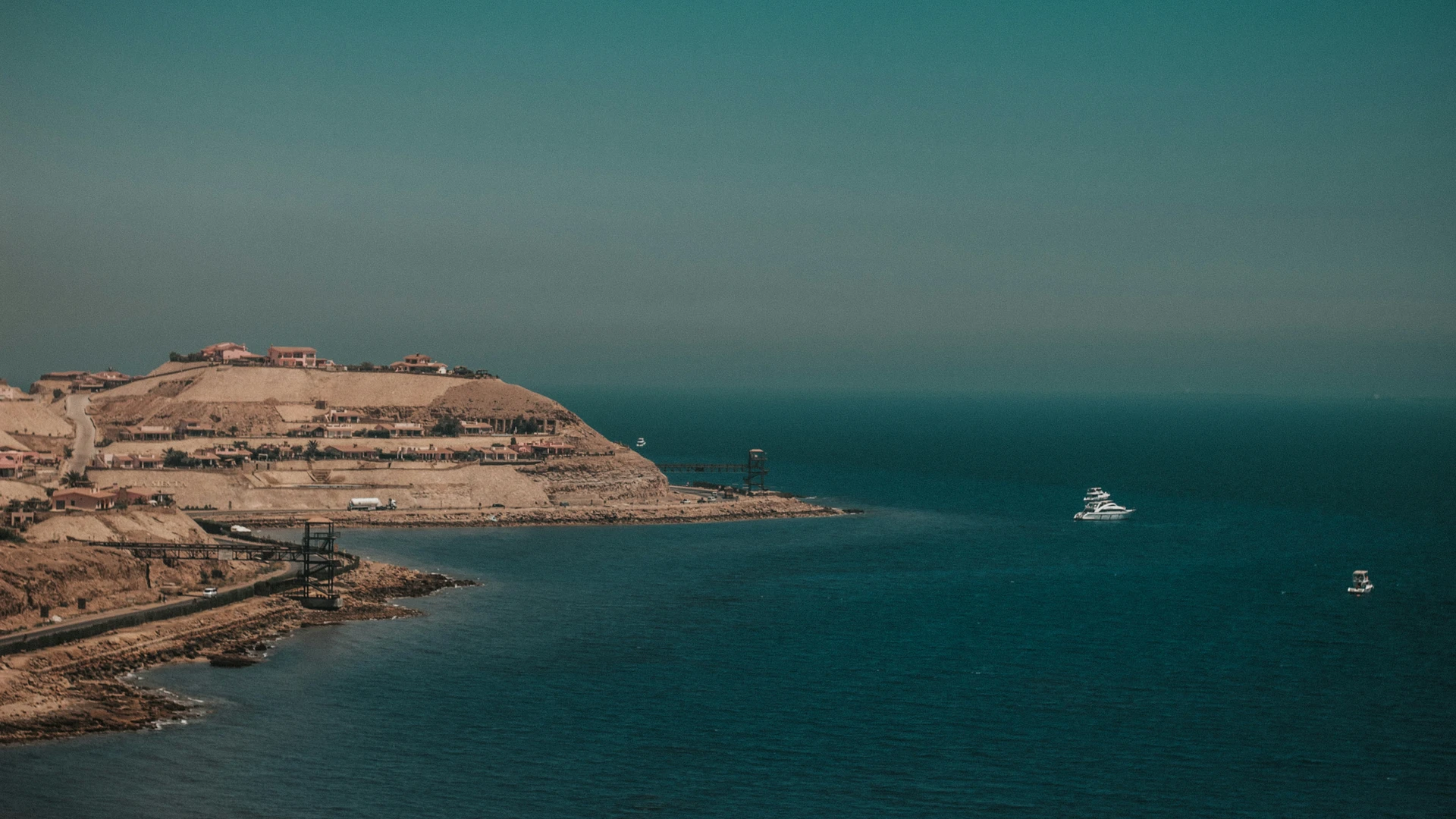 Ain Sokhna, Egypt - White boat on sea near brown mountain under blue sky during daytime