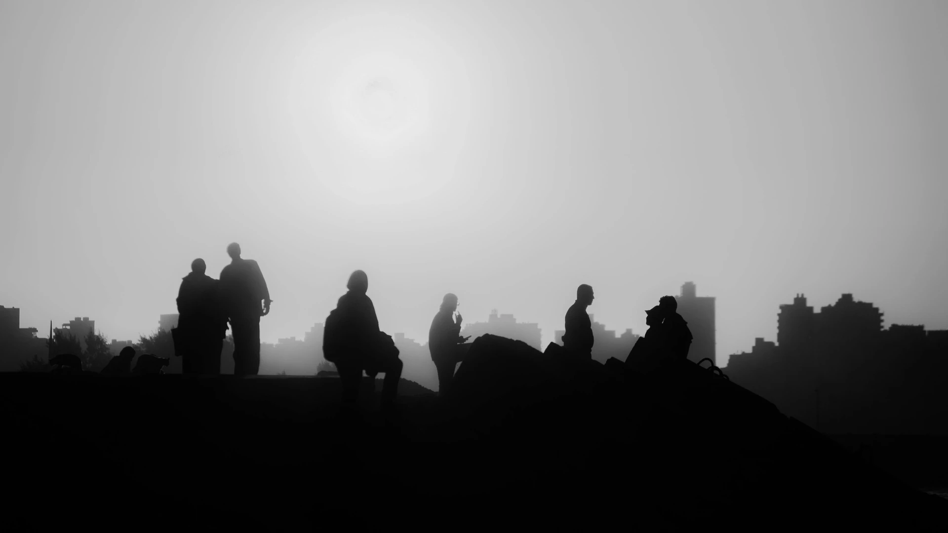 Alexandria, Egypt - Silhouetted figures against alexandria's skyline at sunset, evoking tranquility.