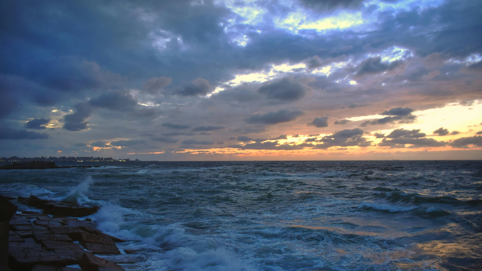 Alexandria, Egypt - Captivating sunset over the mediterranean sea in alexandria, highlighting clouds, waves, and vibrant skies.