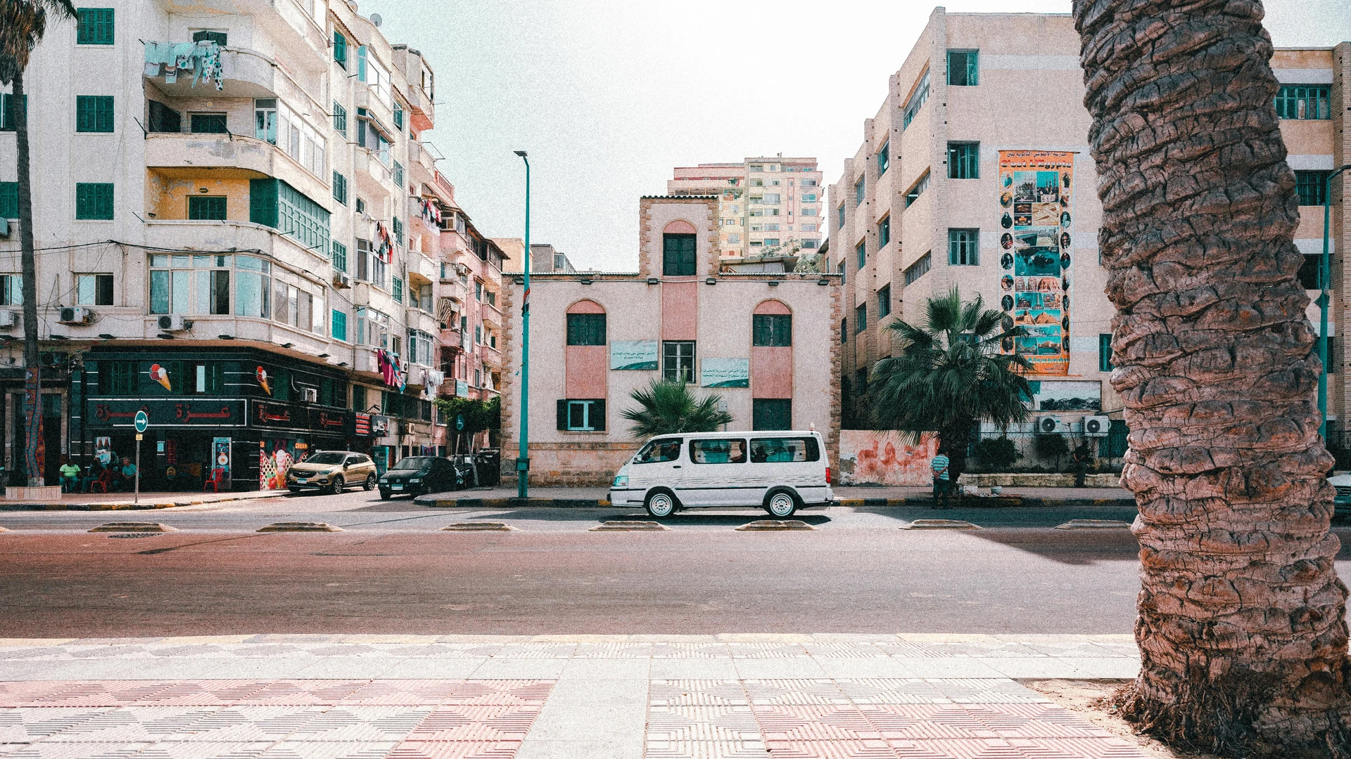 Alexandria, Egypt - Street view of downtown alexandria with vehicles and buildings under bright daylight.