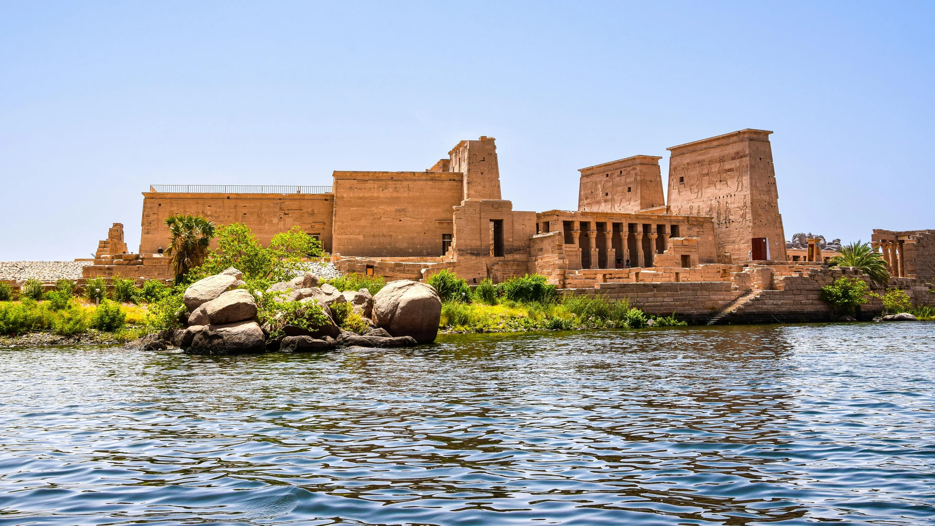 Aswan, Egypt - Scenic view of philae temple on the nile river, showcasing ancient egyptian architecture.