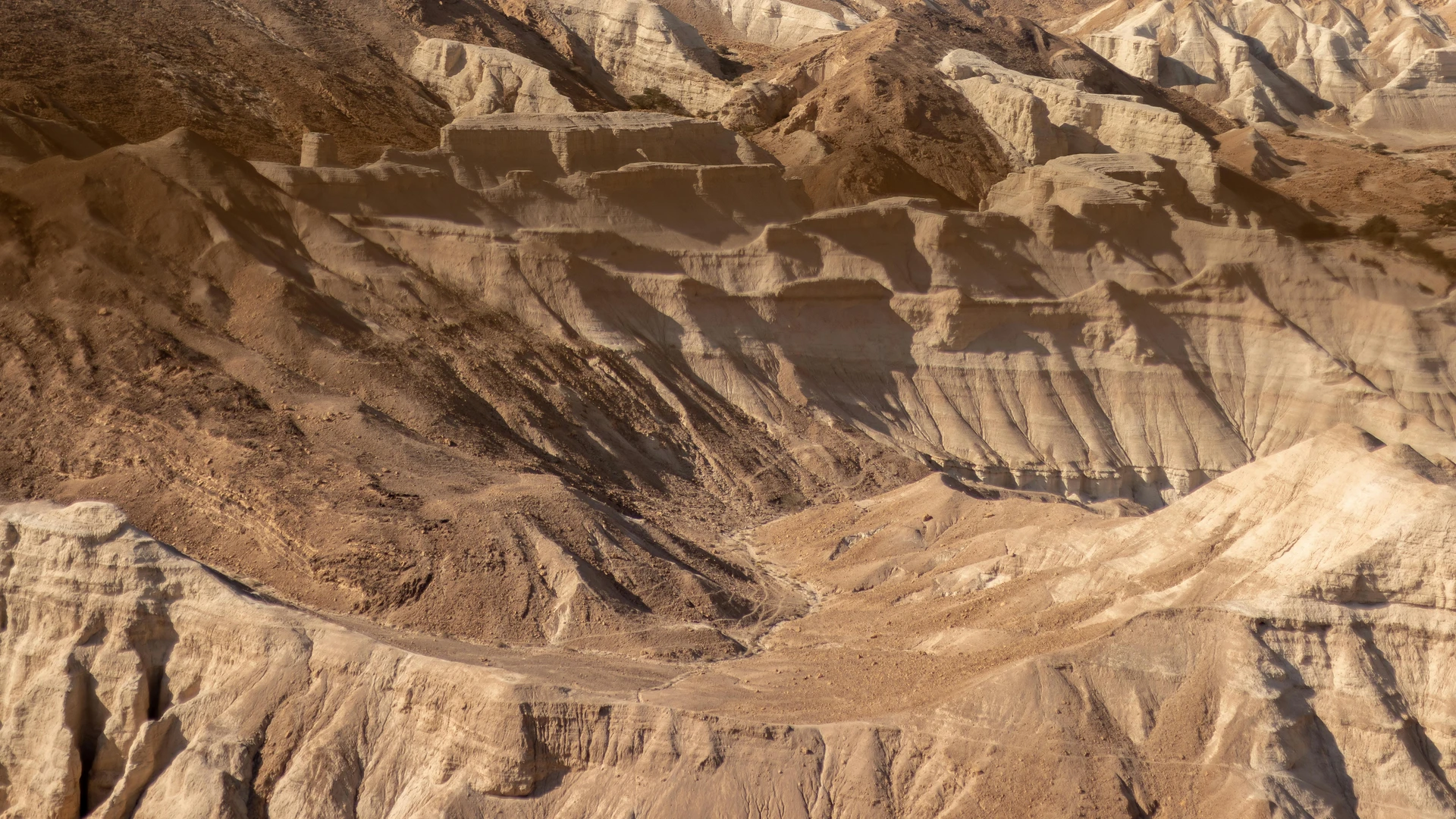 Aswan, Egypt - Explore the serene beauty of a rocky desert landscape with striking geological formations under sunlight.