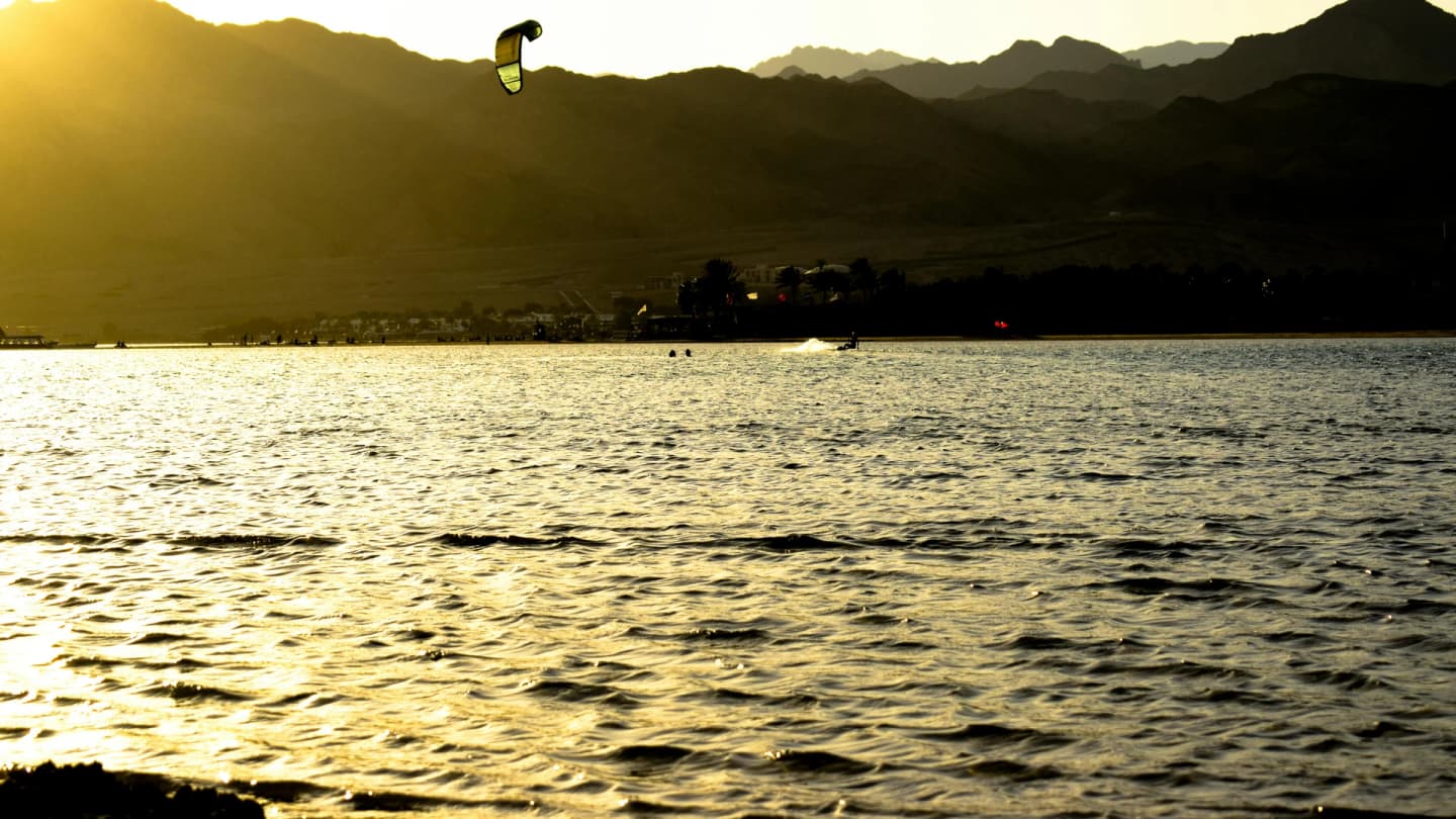Dahab, Egypt - Experience the thrill of kitesurfing during sunset in dahab, egypt, with stunning mountain views.