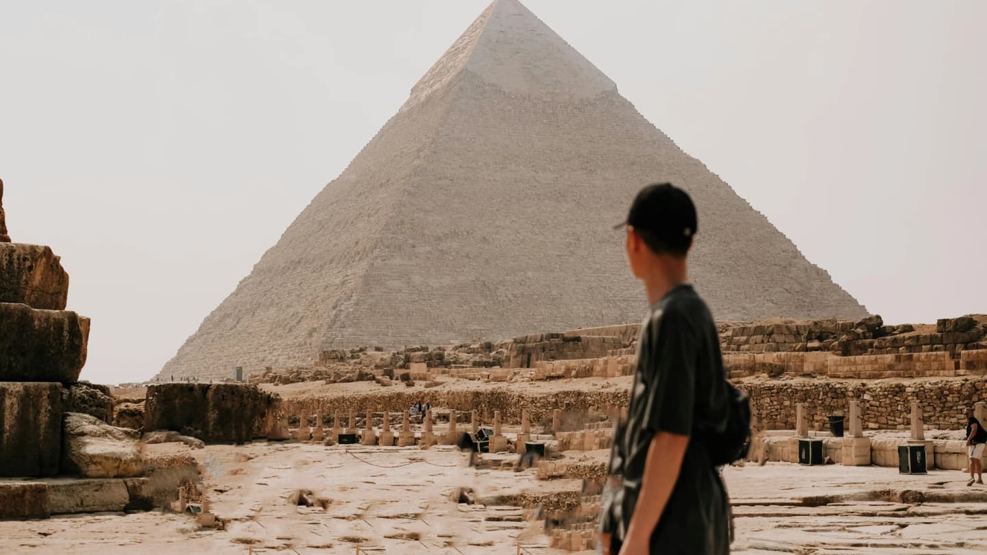 Dahab, Egypt - Tourist observing the majestic great pyramid of giza on a sunny day, egypt.