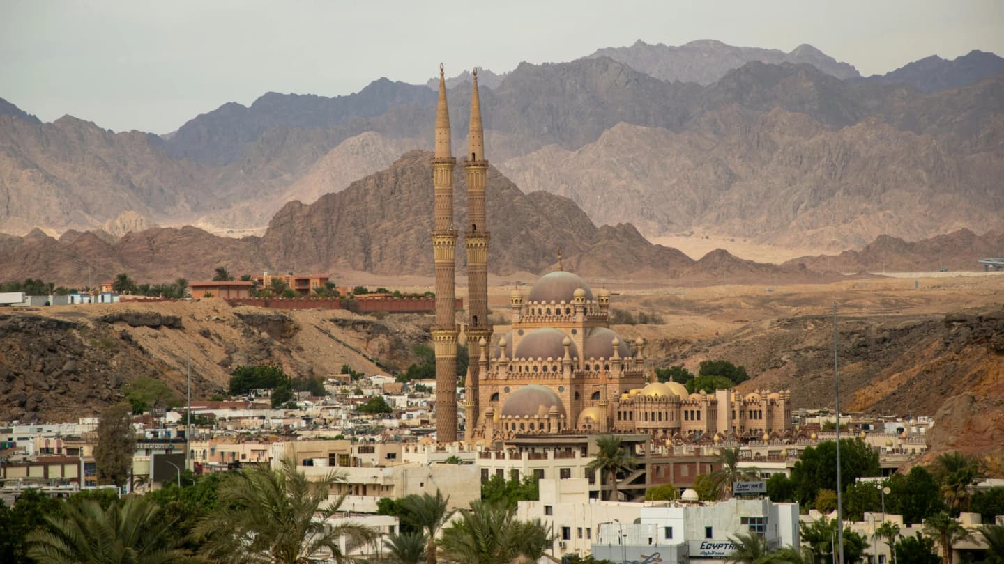 El Gouna, Egypt - Grand mosque with tall minarets in sharm el sheikh set against desert mountains.