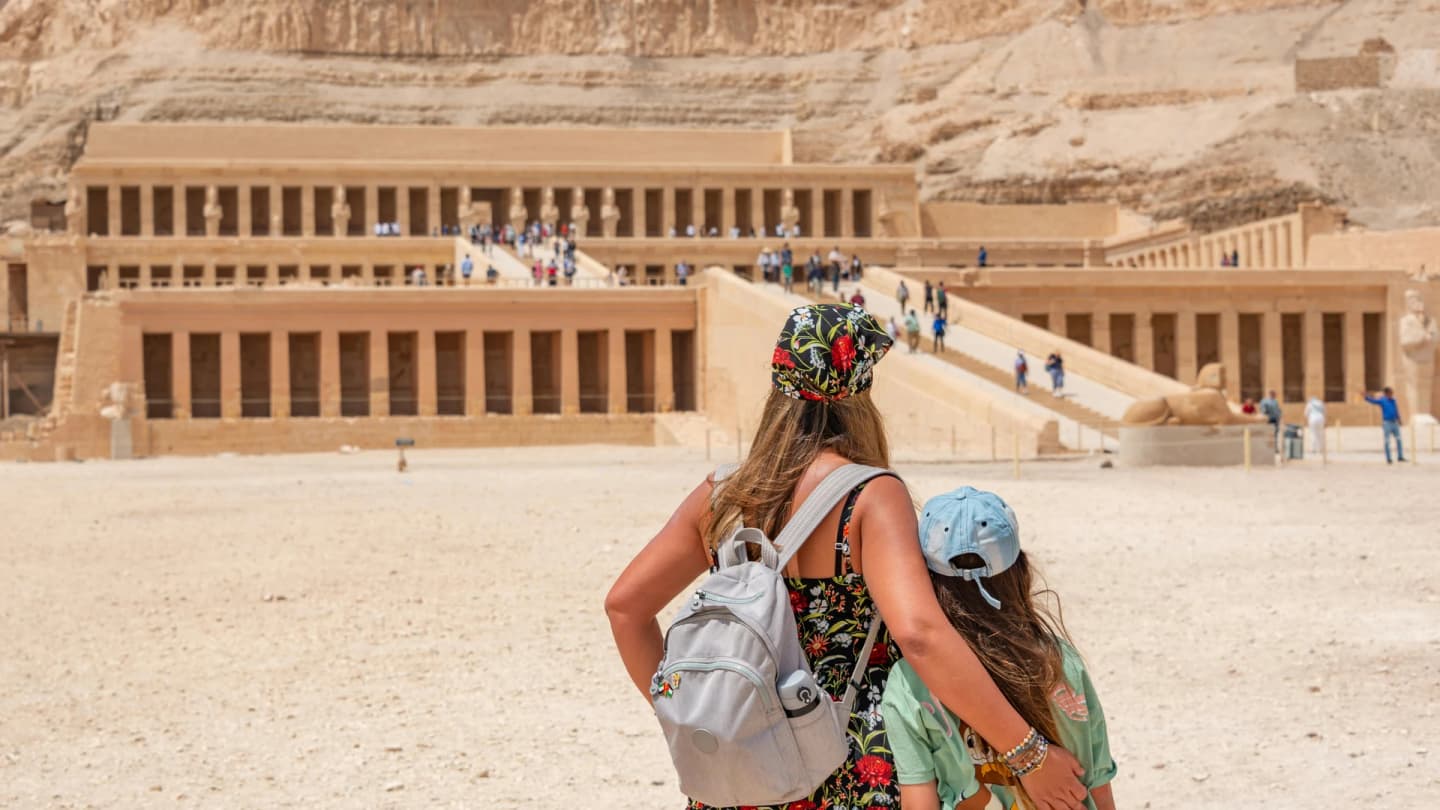 El Gouna, Egypt - Woman and child explore the historic temple of hatshepsut in egypt.