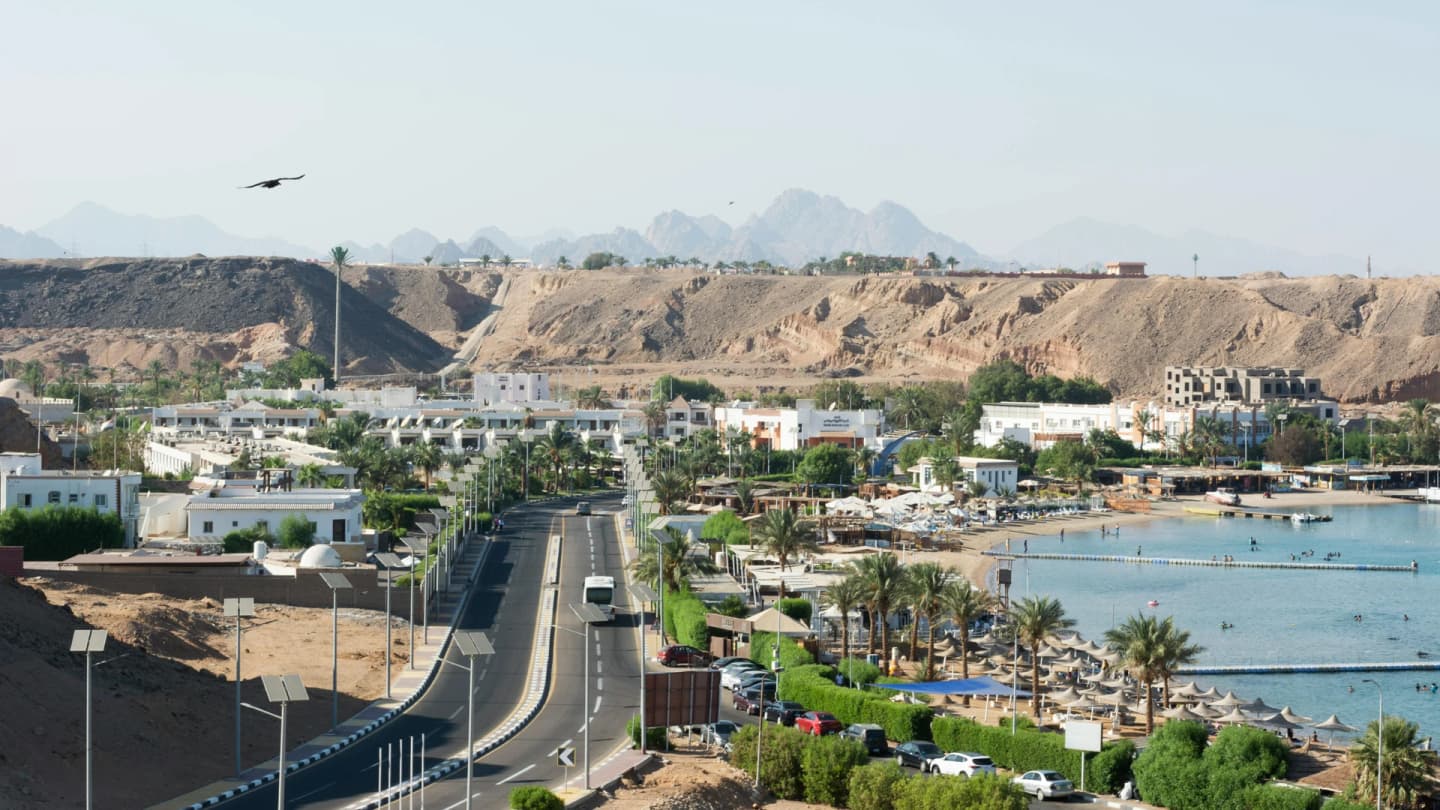 Makadi Bay, Egypt - Panoramic aerial view of the sharm el sheikh coastline and surrounding cityscape, featuring sandy desert hills.