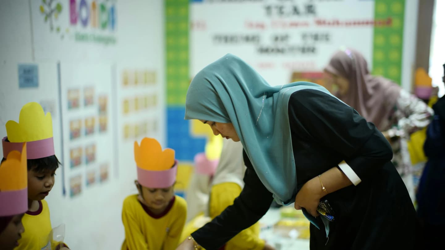 Marsa Alam, Egypt - Teacher guides young students in a classroom activity in shah alam, malaysia.