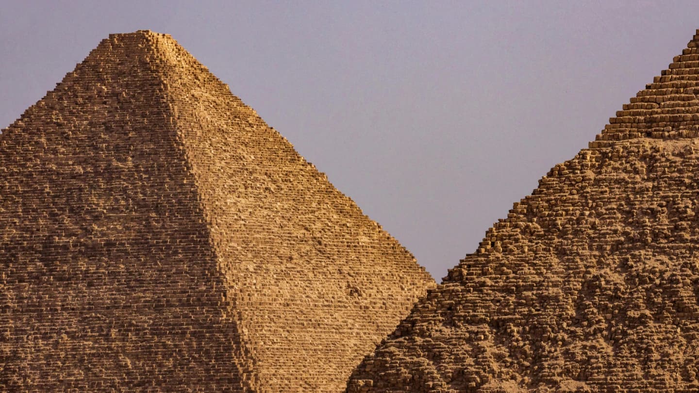 Marsa Alam, Egypt - Close-up view of two iconic egyptian pyramids under a clear blue sky.