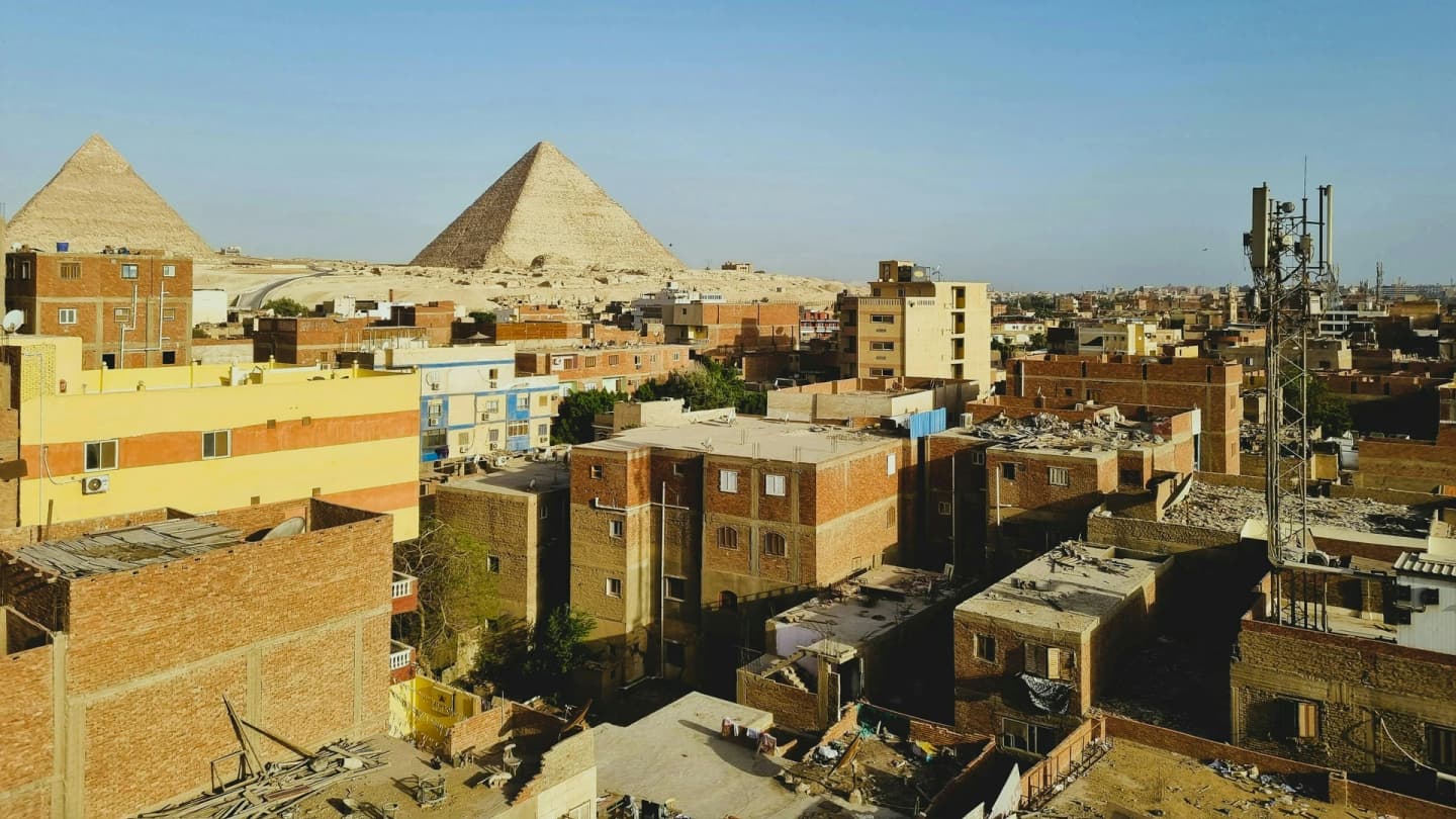 Safaga, Egypt - Great pyramids of giza rise above cityscape.