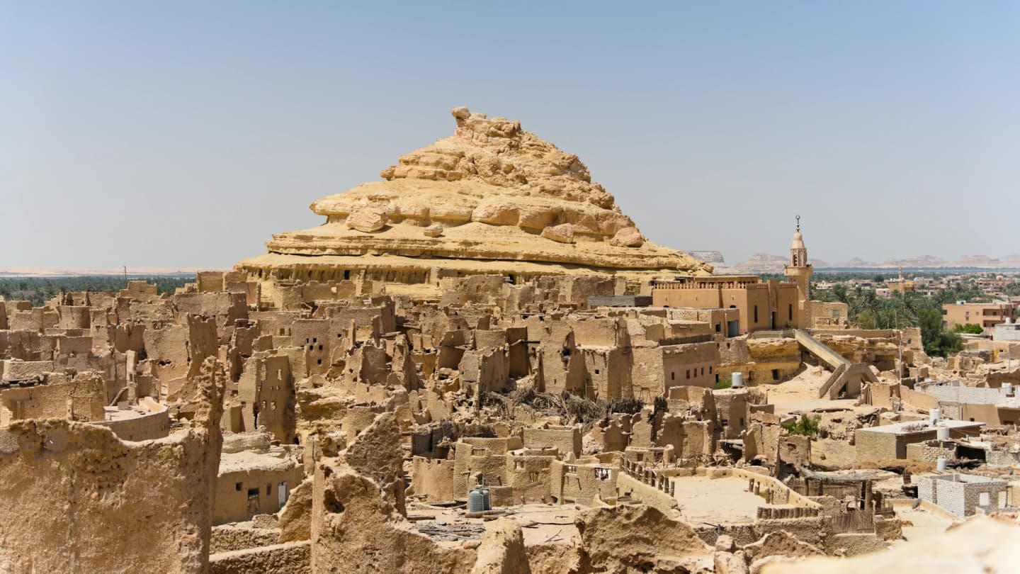 Safaga, Egypt - Ancient mud-brick structures under a clear blue sky.