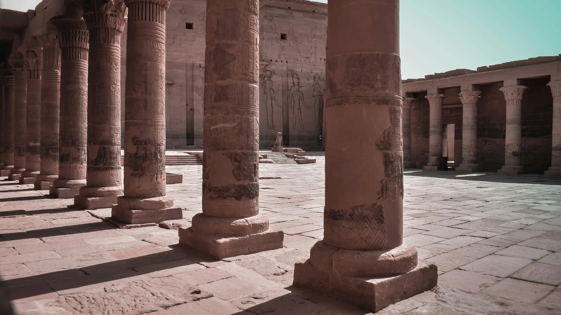 Sahl Hasheesh, Egypt - Majestic columns in an ancient egyptian temple courtyard, aswan, showcasing intricate carvings.