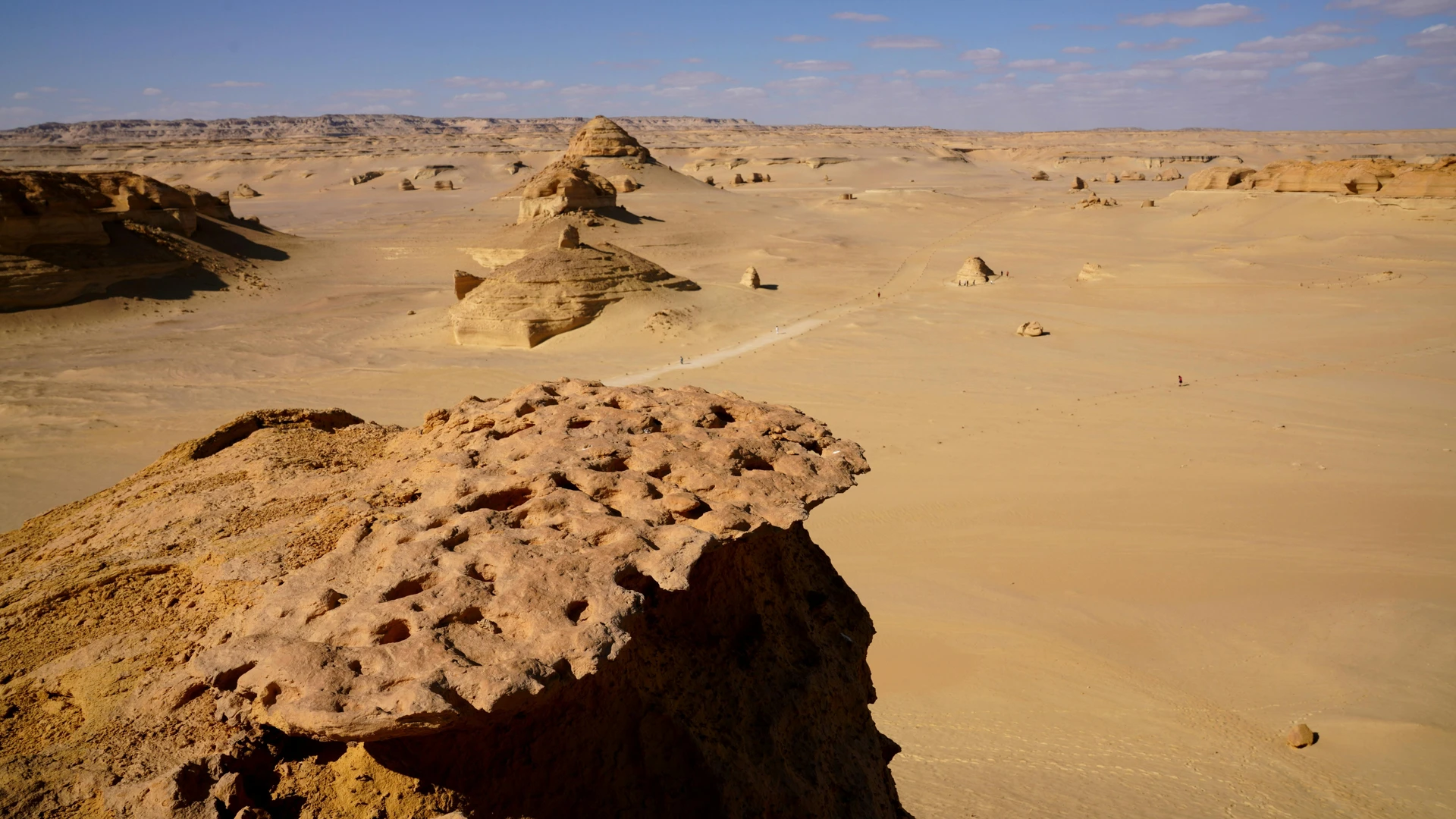 El Alamein, Egypt - Expansive desert landscape in egypt with unique rock formations and clear blue sky.