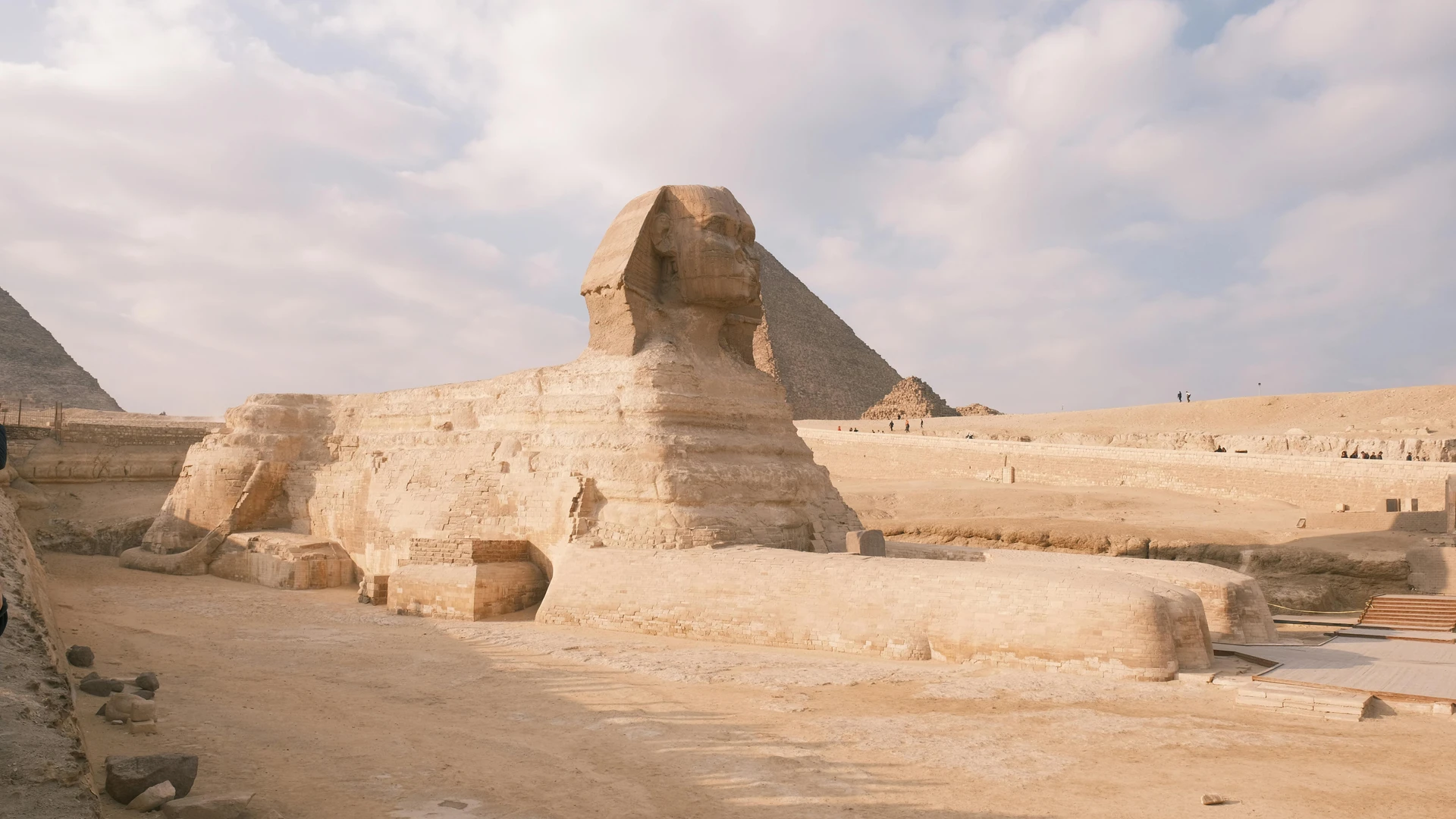Sahl Hasheesh, Egypt - Great sphinx of giza against a backdrop of pyramids and a partly cloudy sky.